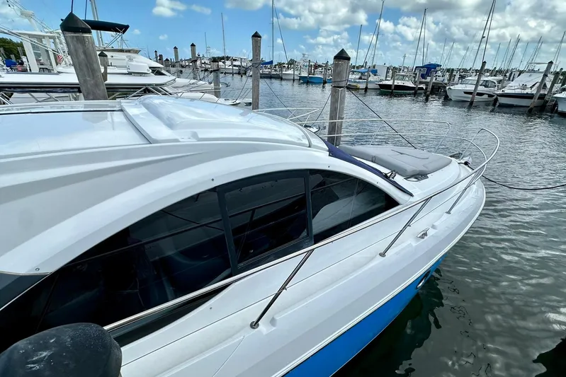  Yacht Photos Pics 2012 Beneteau Gran Turismo 34 yacht docked at marina, under a partly cloudy sky.