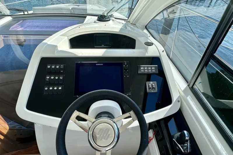  Yacht Photos Pics Cockpit of 2012 Beneteau Gran Turismo 34 with steering wheel and navigation controls.