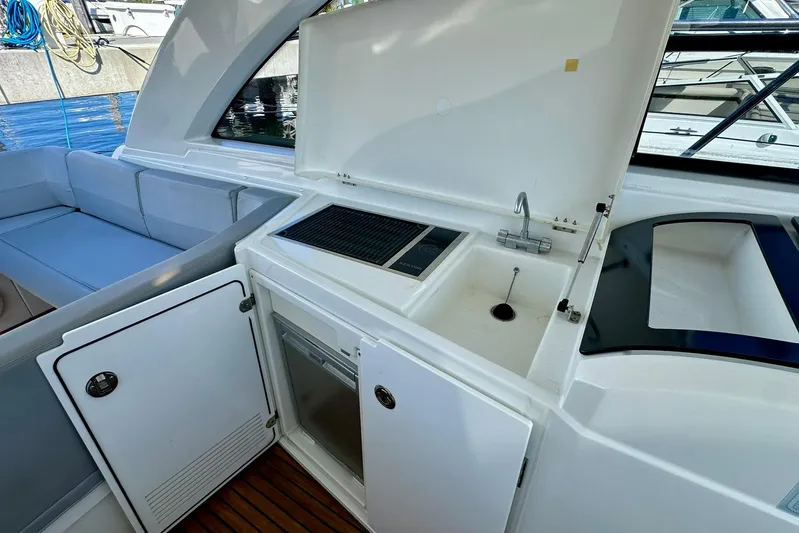  Yacht Photos Pics 2012 Beneteau Gran Turismo 34 yacht interior with kitchenette and seating area.