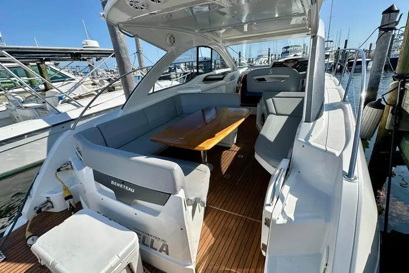  Yacht Photos Pics 2012 Beneteau Gran Turismo 34 yacht interior with seating and wooden table at marina.