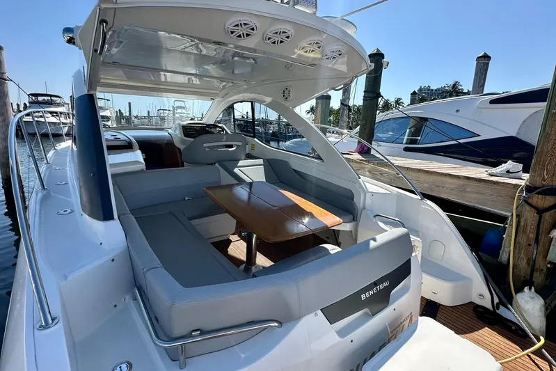  Yacht Photos Pics 2012 Beneteau Gran Turismo 34 yacht with sleek seating and wooden table in marina.