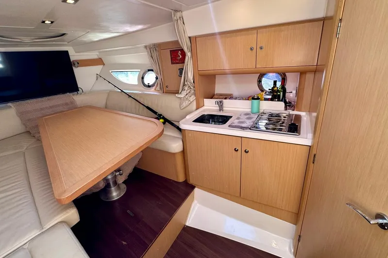  Yacht Photos Pics Luxurious interior of 2012 Beneteau Gran Turismo 34 yacht with kitchenette and seating area.