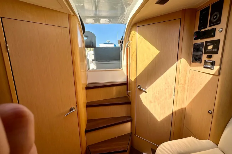  Yacht Photos Pics Interior of 2012 Beneteau Gran Turismo 34 yacht with wooden cabinetry and stairs.