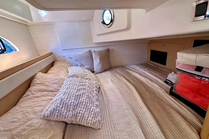  Yacht Photos Pics Cozy cabin interior of 2012 Beneteau Gran Turismo 34 with plush bedding and porthole.