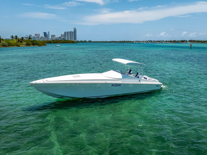  Yacht Photos Pics 2020 Nova 39 Sport boat on clear turquoise water with city skyline in background.