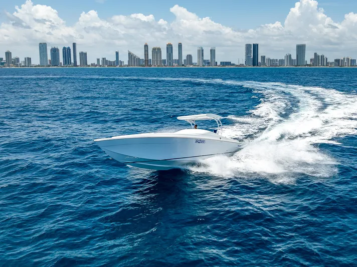  Yacht Photos Pics Nova 39 Sport 2020 boat cruising on ocean with city skyline in background.