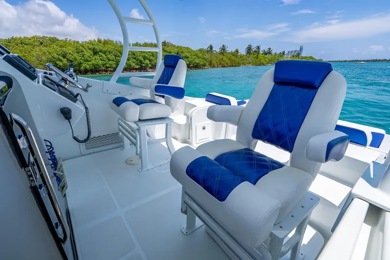  Yacht Photos Pics 2020 Nova 39 Sport boat interior with blue and white seating, ocean view, and lush greenery.