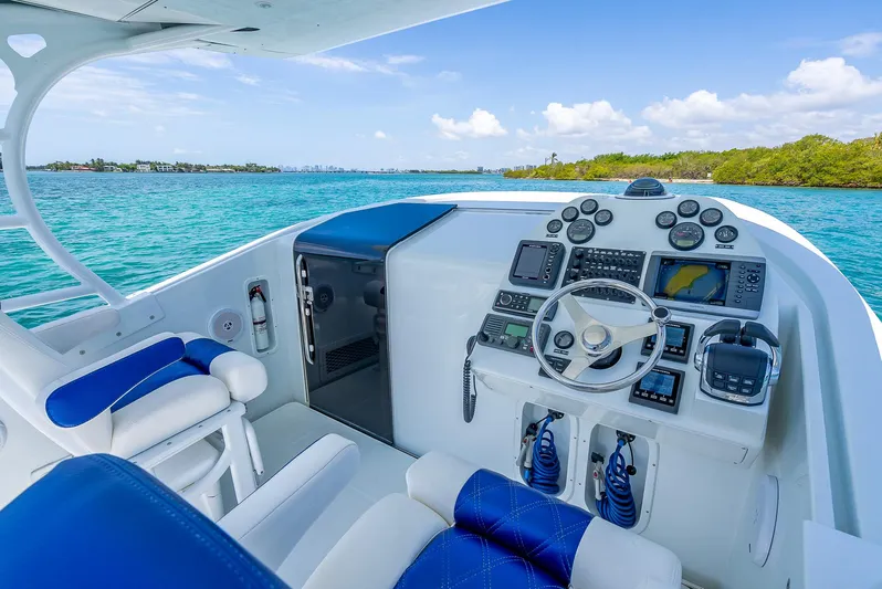  Yacht Photos Pics Cockpit of 2020 Nova 39 Sport boat with blue seating, steering wheel, and control panel.