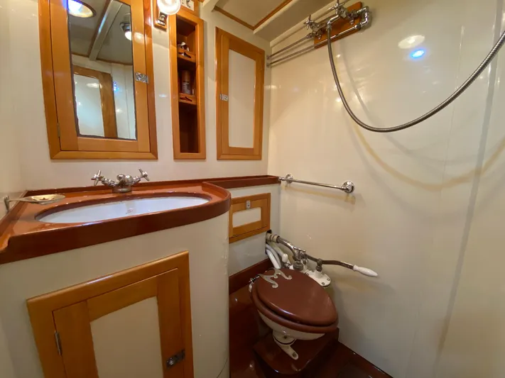 Windigo Yacht Photos Pics Vintage 1956 Hinckley ocean racer bathroom with wooden accents and classic fixtures.