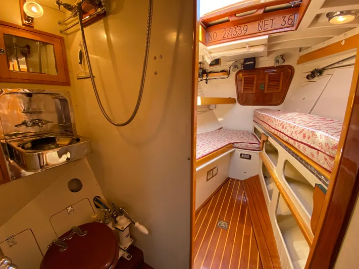 Windigo Yacht Photos Pics Interior of a 1956 Hinckley ocean racer, featuring a cozy cabin and compact bathroom.