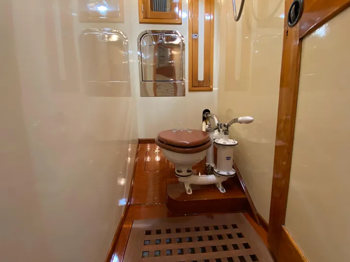 Windigo Yacht Photos Pics Hinckley 1956 ocean racer bathroom with wooden accents and classic marine toilet.