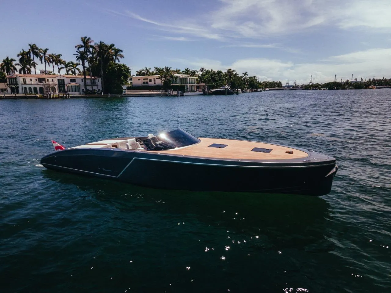 2020 Frauscher 1017 GT luxury yacht cruising near waterfront homes.