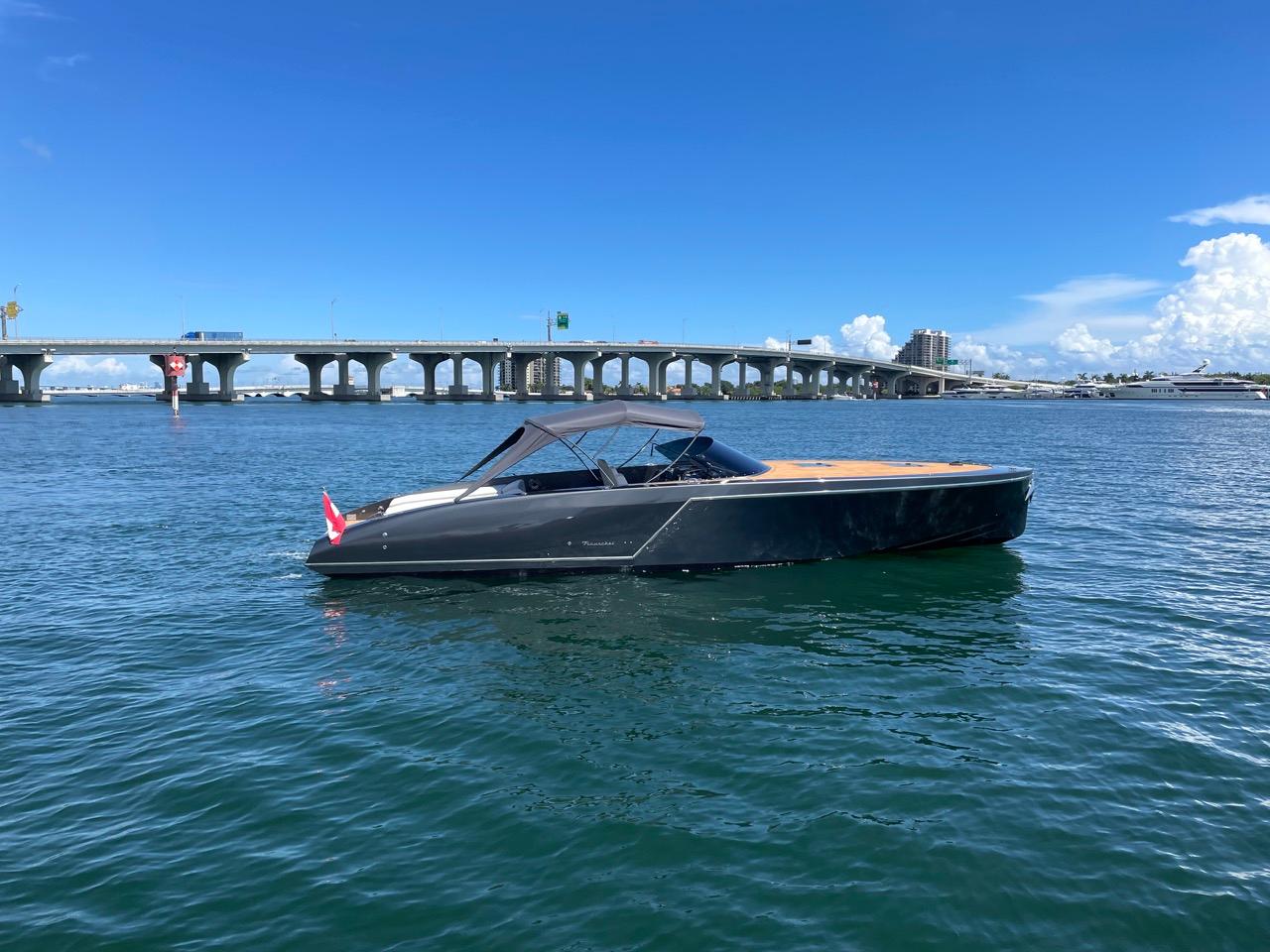 2020 Frauscher 1017 GT luxury boat on water near a bridge.
