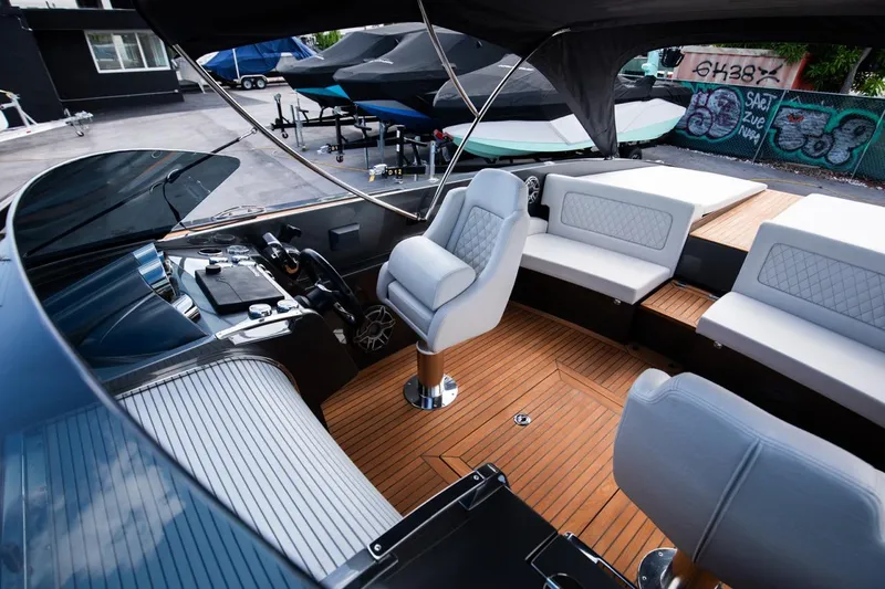  Yacht Photos Pics 2020 Frauscher 1017 GT luxury boat interior with teak flooring and white leather seating.