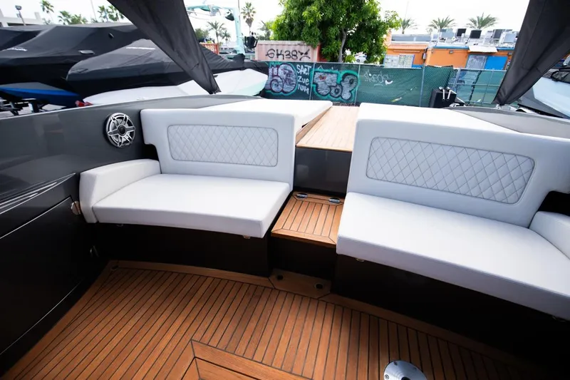  Yacht Photos Pics 2020 Frauscher 1017 GT boat interior with white cushioned seating and teak flooring.