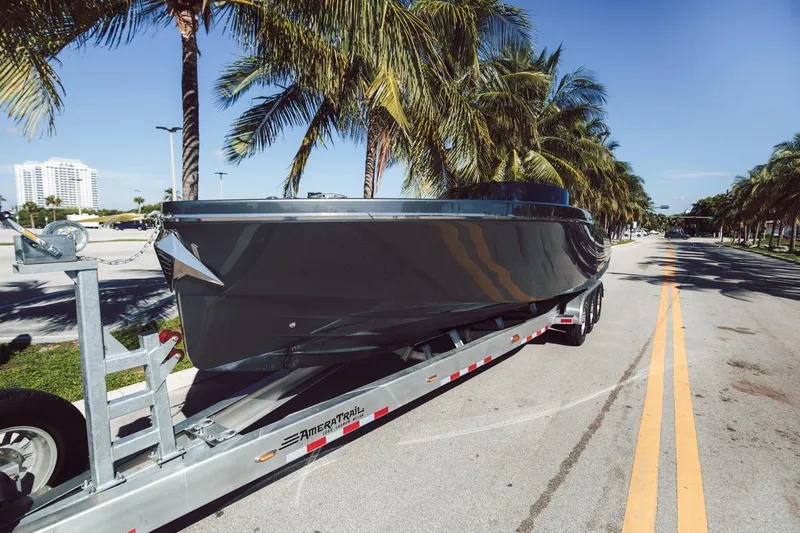  Yacht Photos Pics 2020 Frauscher 1017 GT boat on trailer, parked on a palm-lined street.