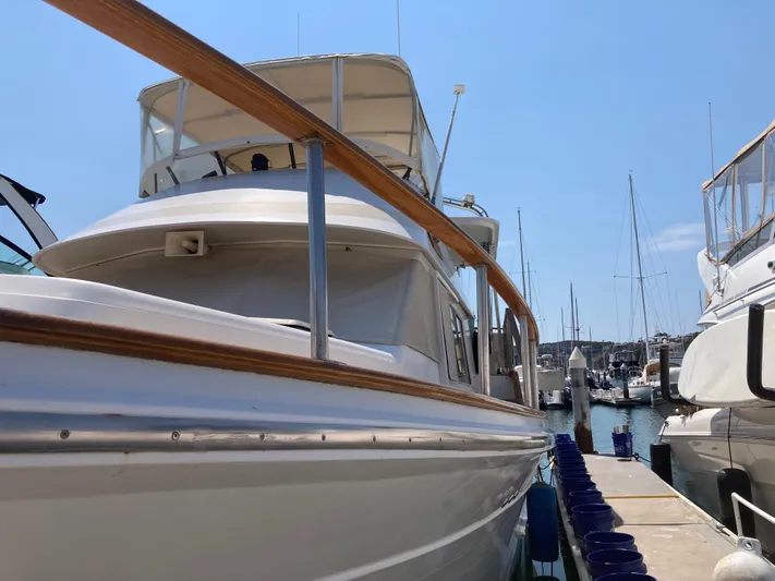  Yacht Photos Pics 1985 Offshore Yachts 48 Yachtfisher docked at marina, showcasing sleek design and craftsmanship.