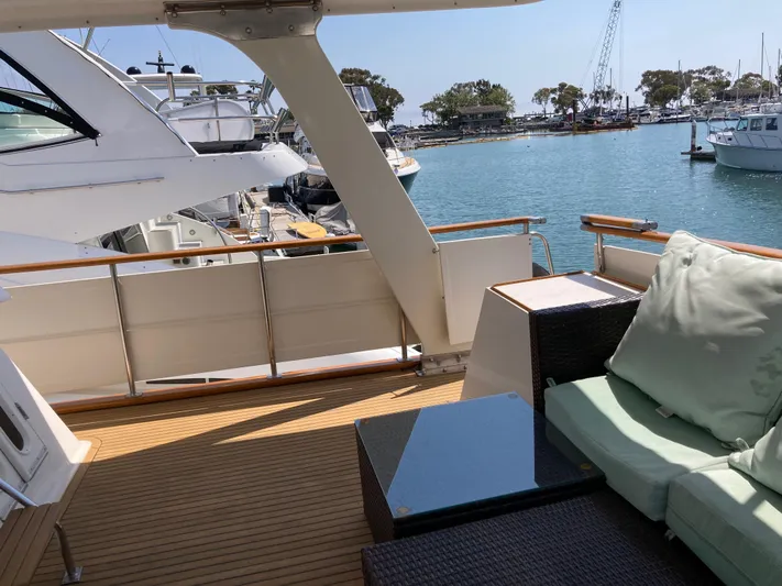  Yacht Photos Pics 1985 Offshore Yachts 48 Yachtfisher deck with seating, overlooking marina and boats.