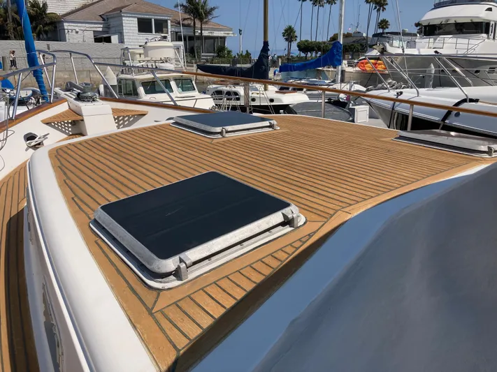  Yacht Photos Pics 1985 Offshore Yachts 48 Yachtfisher with teak deck, docked at marina.