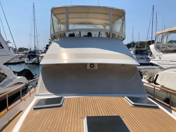 Yacht Photos Pics 1985 Offshore Yachts 48 Yachtfisher docked, showcasing spacious deck and flybridge.