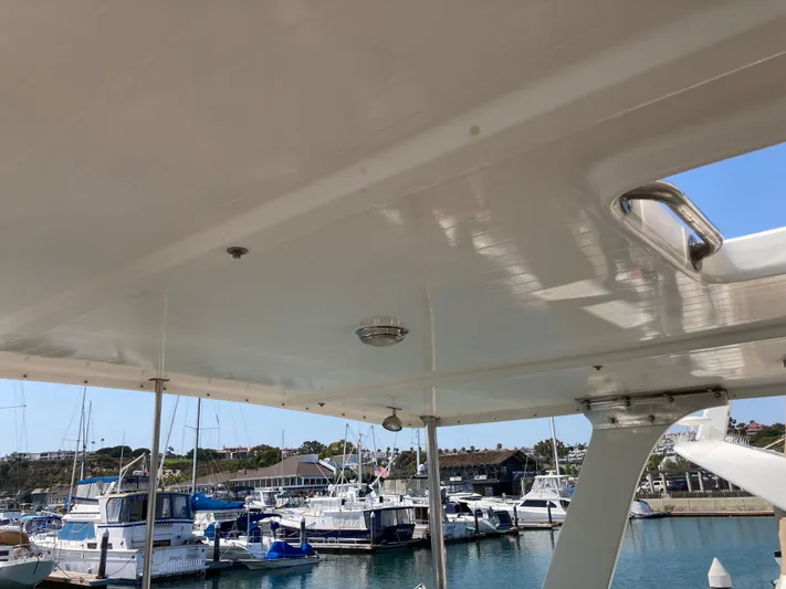  Yacht Photos Pics 1985 Offshore Yachts 48 Yachtfisher docked at marina, view from under canopy.