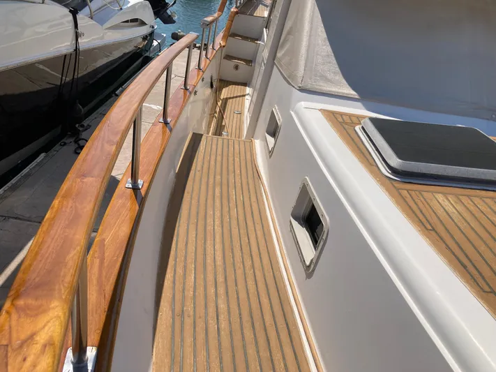  Yacht Photos Pics 1985 Offshore Yachts 48 Yachtfisher deck with wooden railings and sleek design.