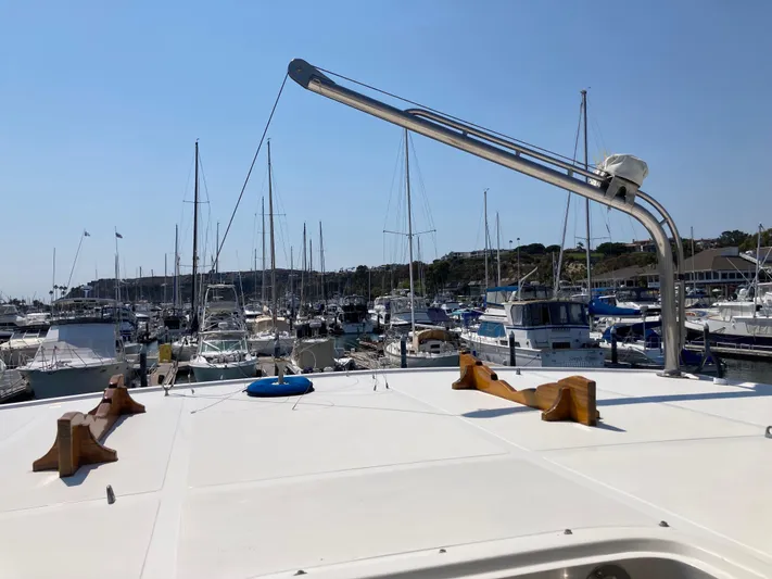 Yacht Photos Pics 1985 Offshore Yachts 48 Yachtfisher in marina, surrounded by various boats under clear sky.