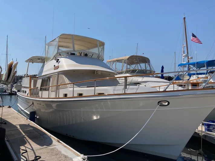 Yacht Photos Pics 1985 Offshore Yachts 48 Yachtfisher docked at marina under clear blue sky.