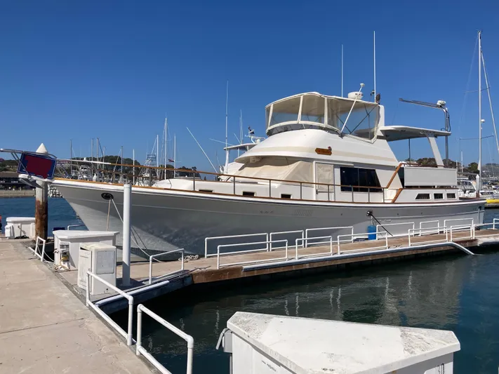  Yacht Photos Pics 1985 Offshore Yachts 48 Yachtfisher docked at marina under clear blue sky.
