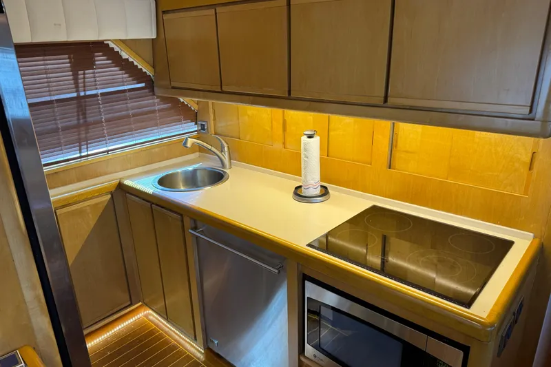  Yacht Photos Pics 1996 Bertam Convertible yacht kitchen with sink, stovetop, and microwave.