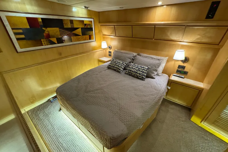  Yacht Photos Pics Luxurious cabin interior of a 1996 Bertam Convertible yacht with modern decor and cozy bedding.