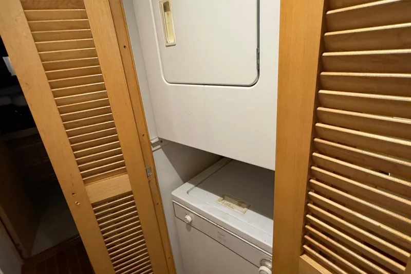  Yacht Photos Pics Laundry area with stacked washer and dryer in 1996 Bertam Convertible.