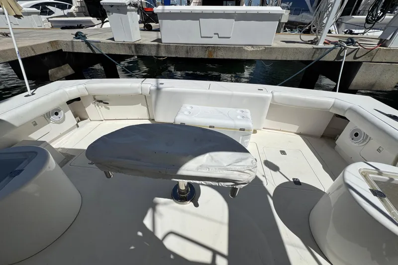  Yacht Photos Pics 1996 Bertam Convertible boat interior with seating and storage at a marina.