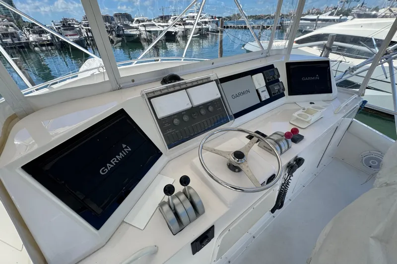  Yacht Photos Pics 1996 Bertam Convertible yacht helm with Garmin navigation, docked at marina.
