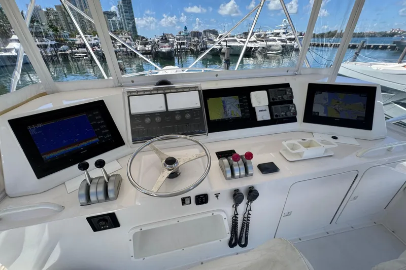  Yacht Photos Pics 1996 Bertam Convertible yacht helm with navigation screens and controls, docked at marina.