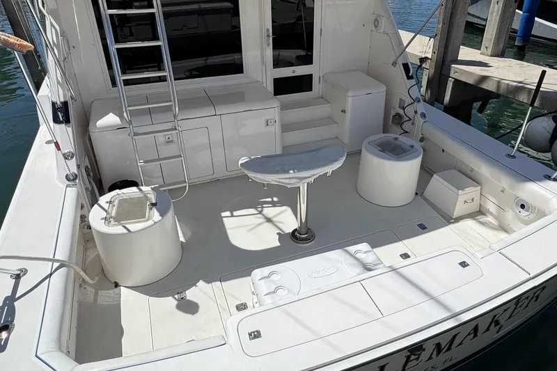  Yacht Photos Pics 1996 Bertam Convertible boat deck with seating, ladder, and storage compartments.