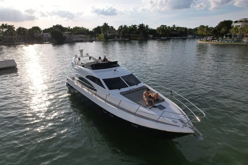  Yacht Photos Pics Azimut 54 yacht from 1997 cruising on a serene waterway at sunset.