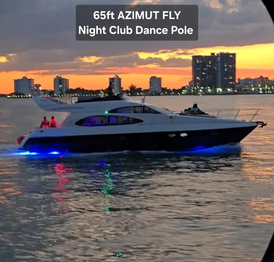  Yacht Photos Pics Luxury Azimut 54 yacht cruising at sunset with city skyline backdrop.