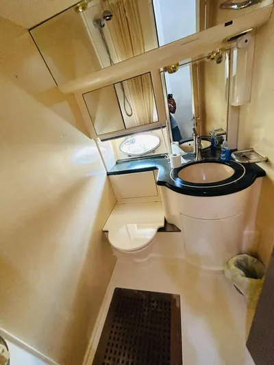  Yacht Photos Pics Bathroom interior of a 1997 Azimut 54 yacht, featuring a sink and toilet.