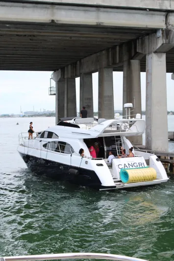  Yacht Photos Pics Azimut 54 yacht from 1997 navigating under a bridge with passengers onboard.