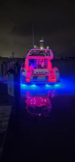  Yacht Photos Pics Azimut 54 yacht, 1997 model, illuminated with vibrant red and blue lights at night.