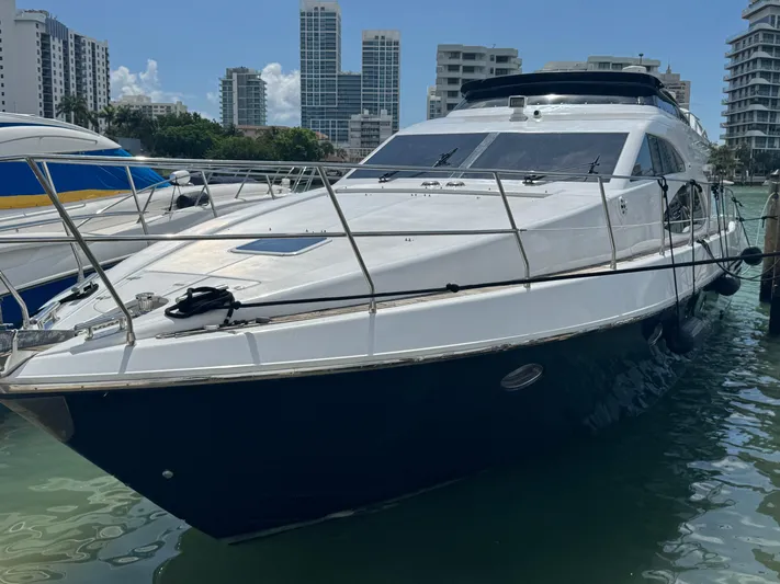  Yacht Photos Pics Luxury 1997 Azimut 54 yacht docked in marina, surrounded by modern buildings.