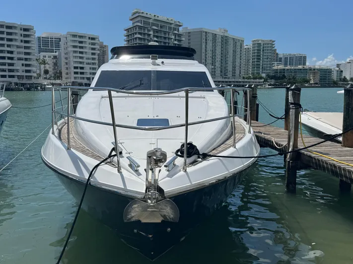  Yacht Photos Pics Front view of a 1997 Azimut 54 yacht docked in a marina.