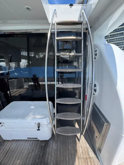  Yacht Photos Pics Stainless steel staircase on 1997 Azimut 54 yacht with wooden deck and white cooler.