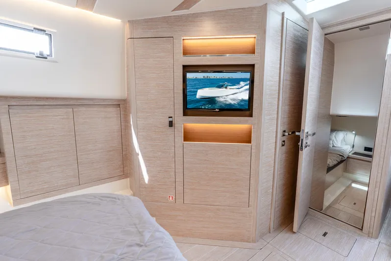  Yacht Photos Pics Interior of 2021 Pardo Yachts 43, featuring modern wood paneling and a built-in TV.