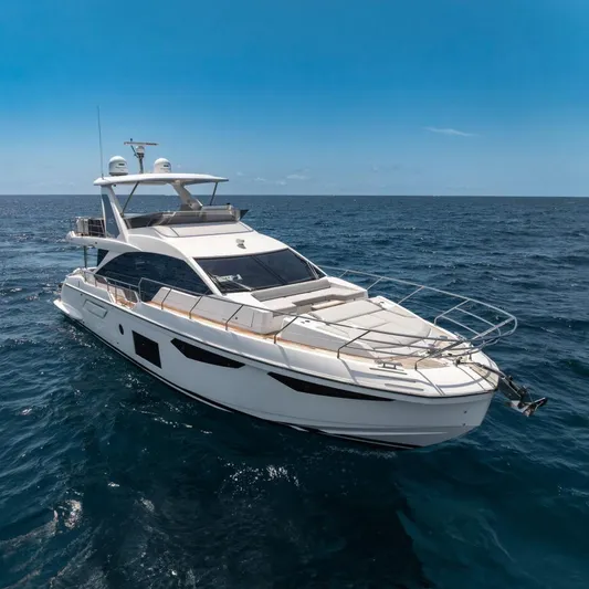  Yacht Photos Pics Azimut Fly 60 yacht cruising on open sea under clear blue sky, 2022 model.