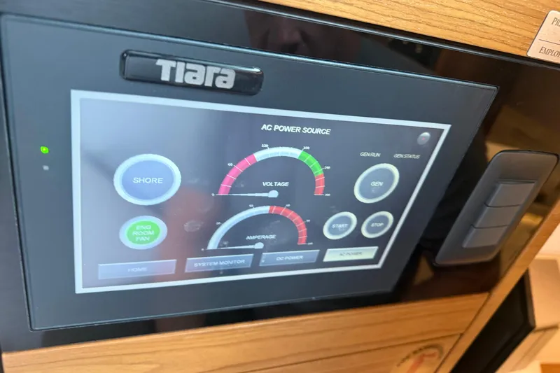  Yacht Photos Pics Control panel of 2023 Tiara Yachts 48 LS displaying AC power source settings.