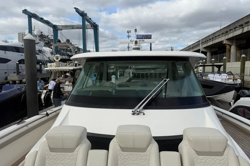  Yacht Photos Pics 2023 Tiara Yachts 48 LS at marina, front view with seating and windshield.