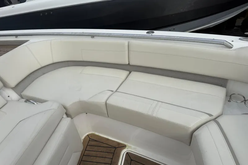  Yacht Photos Pics 2023 Tiara Yachts 48 LS interior seating with white upholstery and wooden flooring.