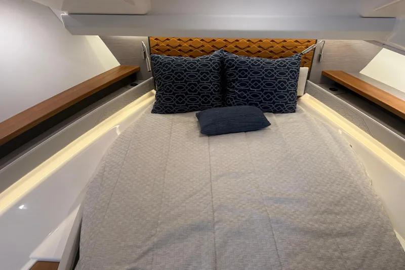  Yacht Photos Pics Luxurious cabin interior of 2023 Tiara Yachts 48 LS with elegant bedding.